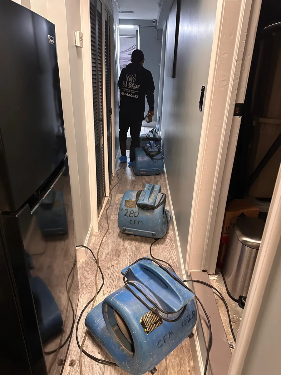 All Star Restoration crew setting up air movers to dry a Brooklyn home